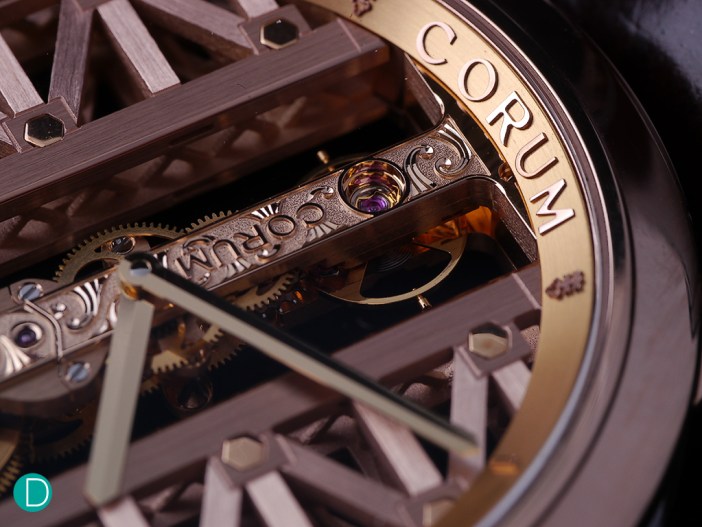 The hand engraved bridge, showing the brand logo is done in relief engraving. As are the decorative swirls on the textured face of the bridge. The sides are somewhat raised and polished.
