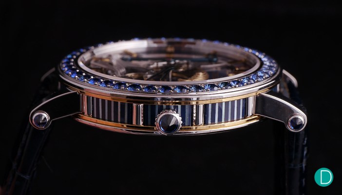 The case side showing the fillets of blue sapphire inserted into the platinum case. And a sapphire cabochon on the crown.